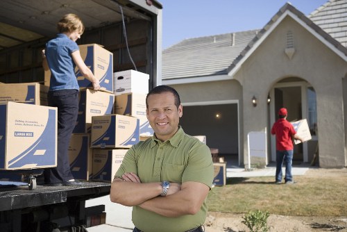 Moving team organizing boxes during packing services in Mordenpark